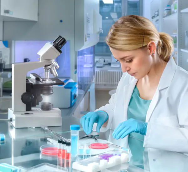 scientist performing experiments in her laboratory using scientific equipment